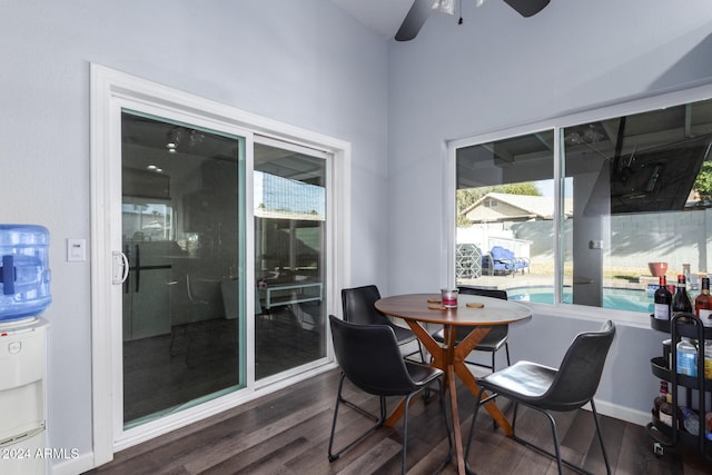 dining area with ceiling fan and dark hardwood / wood-style flooring