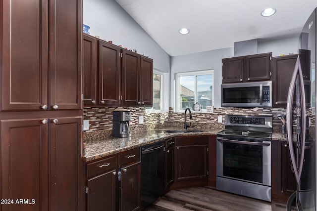 kitchen featuring sink, lofted ceiling, stainless steel appliances, and tasteful backsplash