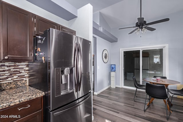 kitchen with lofted ceiling, stainless steel fridge with ice dispenser, ceiling fan, dark stone countertops, and wood-type flooring