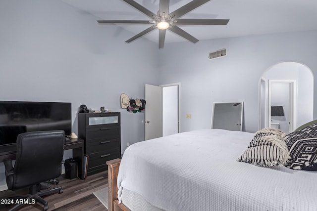 bedroom featuring ceiling fan, dark hardwood / wood-style flooring, and lofted ceiling