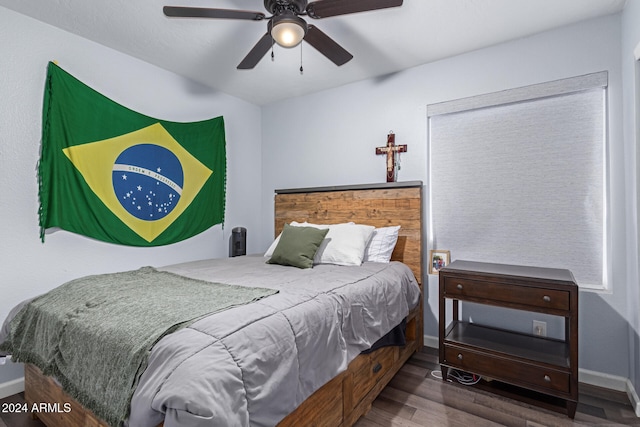 bedroom with ceiling fan and hardwood / wood-style flooring