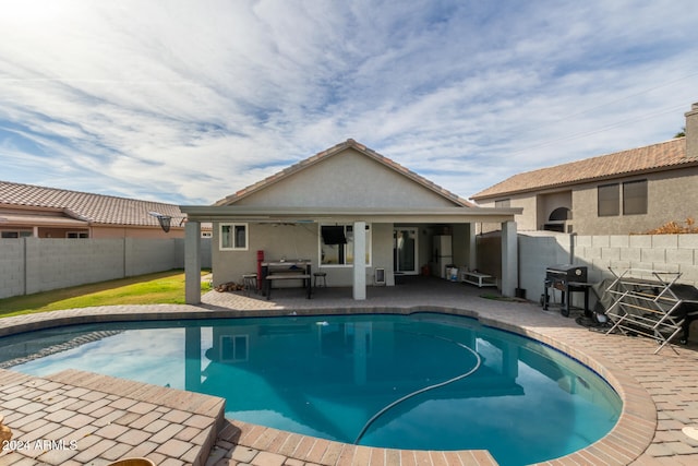 view of pool with outdoor lounge area, a patio area, and grilling area