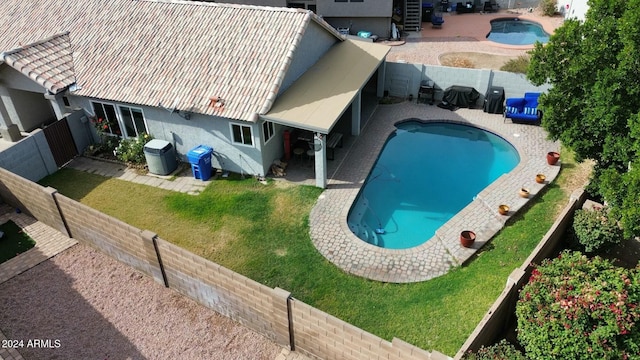 view of swimming pool with a yard and a patio