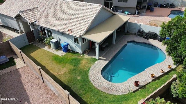 view of pool with a yard and a patio