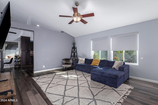 living room featuring lofted ceiling, ceiling fan, and dark wood-type flooring