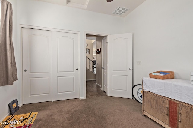 bedroom with a closet, visible vents, and carpet flooring