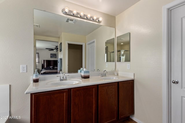 ensuite bathroom featuring double vanity, ensuite bath, a sink, and visible vents