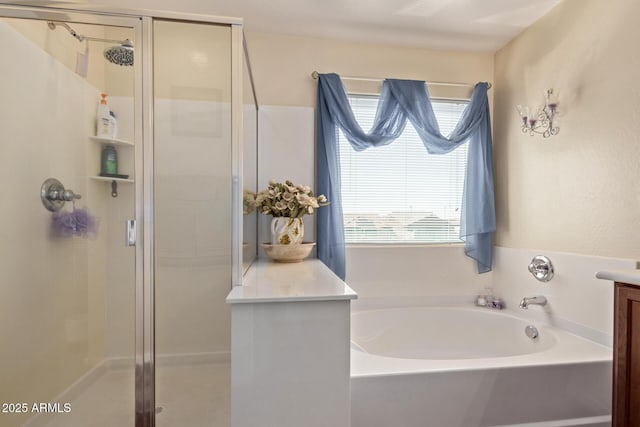 bathroom featuring a garden tub, a shower stall, and a healthy amount of sunlight