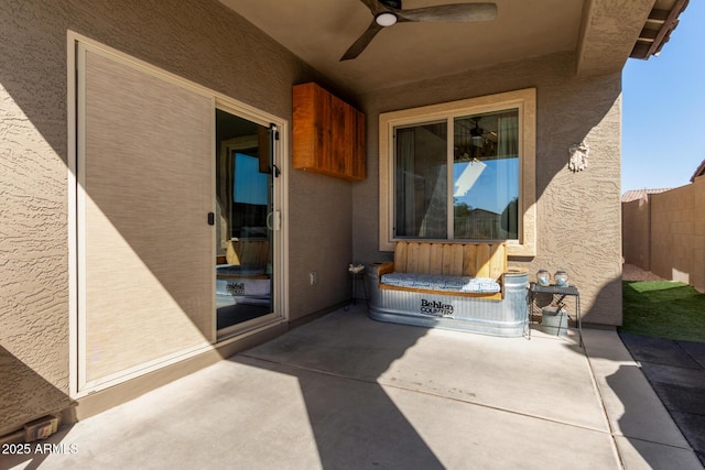 view of patio / terrace featuring ceiling fan and fence