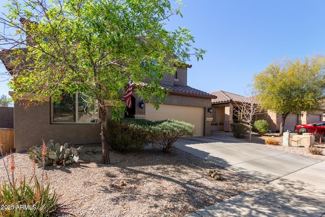 view of front facade with a garage, concrete driveway, a chimney, a tiled roof, and stucco siding