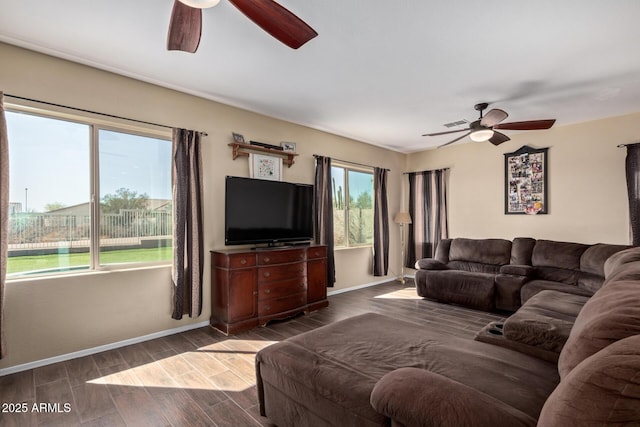 living area with ceiling fan, baseboards, and wood finished floors