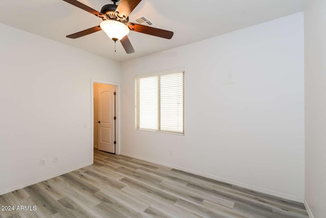 empty room with light hardwood / wood-style floors and ceiling fan