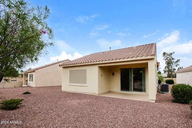 rear view of house with cooling unit and a patio