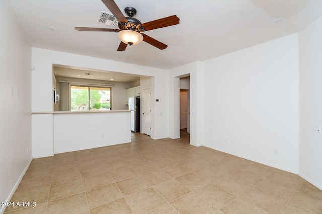 unfurnished room with ceiling fan and light tile patterned floors