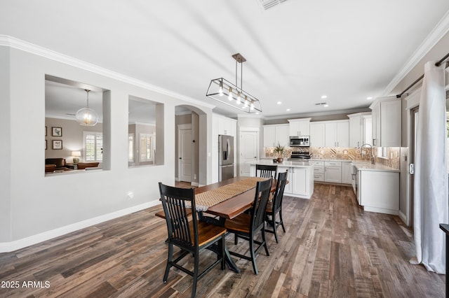 824 E Chelsea Dr, San Tan Valley, AZ 85140 - dining space featuring dark wood-style flooring, ornamental molding, baseboards, and arched walkways