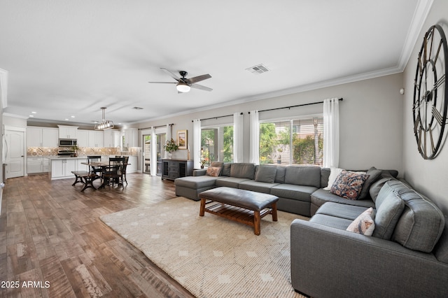824 E Chelsea Dr, San Tan Valley, AZ 85140 - living area with light wood-type flooring, ceiling fan, visible vents, and crown molding