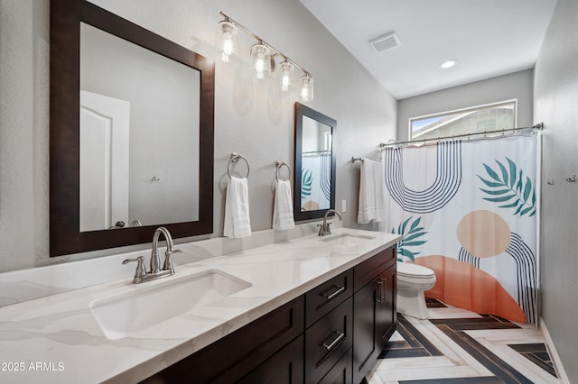 824 E Chelsea Dr, San Tan Valley, AZ 85140 - bathroom with double vanity, visible vents, toilet, and a sink