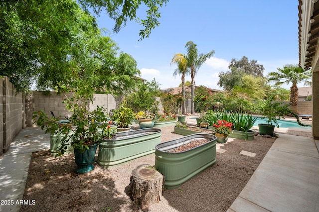 824 E Chelsea Dr, San Tan Valley, AZ 85140 - view of patio featuring a garden, a fenced backyard, and a fenced in pool