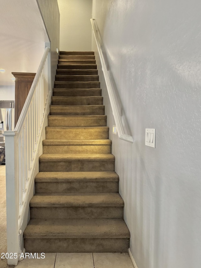 stairs featuring tile patterned flooring