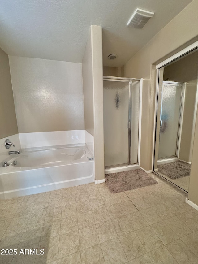 bathroom with visible vents, a stall shower, and a garden tub