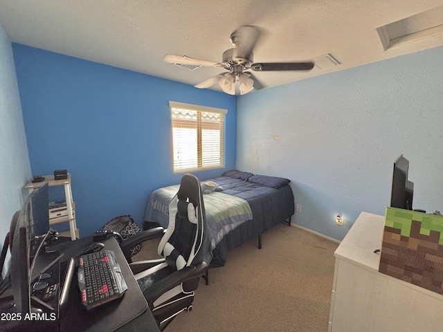 carpeted bedroom featuring attic access and ceiling fan