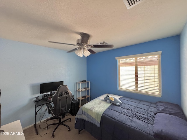 bedroom featuring visible vents, carpet, a ceiling fan, and a textured ceiling