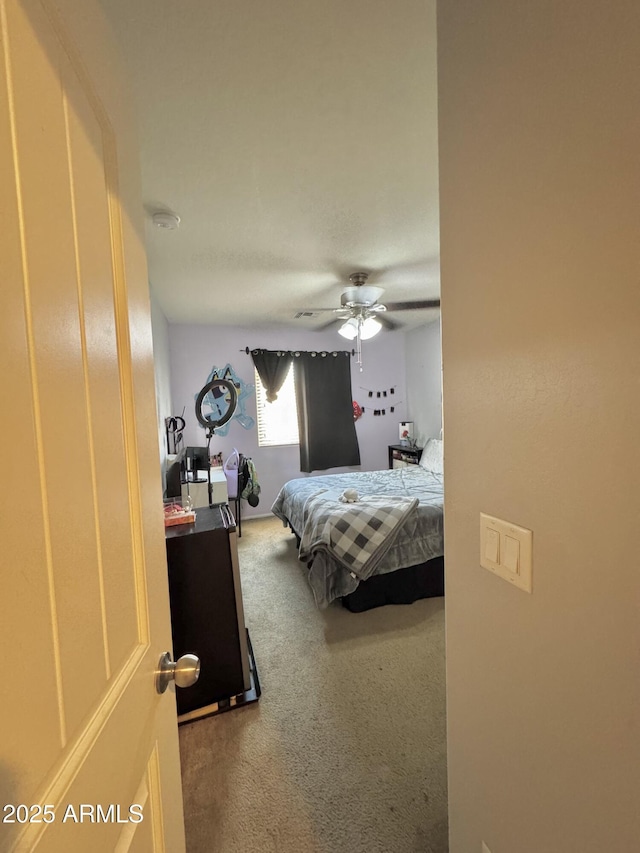 carpeted bedroom with ceiling fan