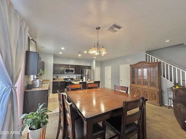 dining room featuring visible vents, light colored carpet, stairs, recessed lighting, and a notable chandelier