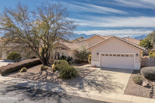 view of front of home featuring a garage and a mountain view