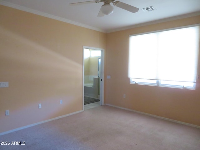 carpeted empty room with ceiling fan and ornamental molding