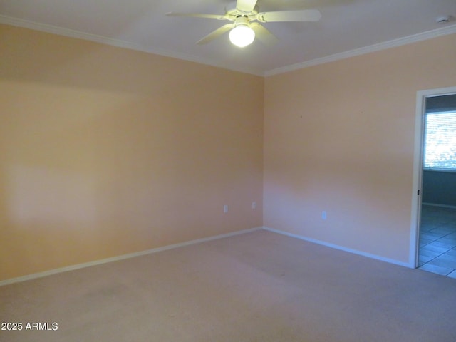 empty room featuring crown molding, light colored carpet, and ceiling fan