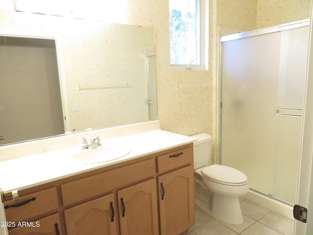 bathroom featuring vanity, toilet, an enclosed shower, and tile patterned flooring