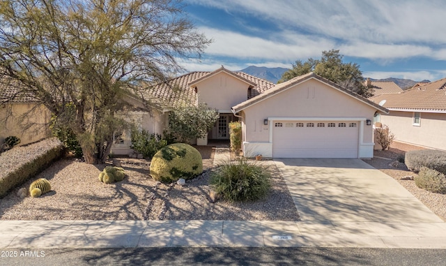 view of front of property with a mountain view and a garage