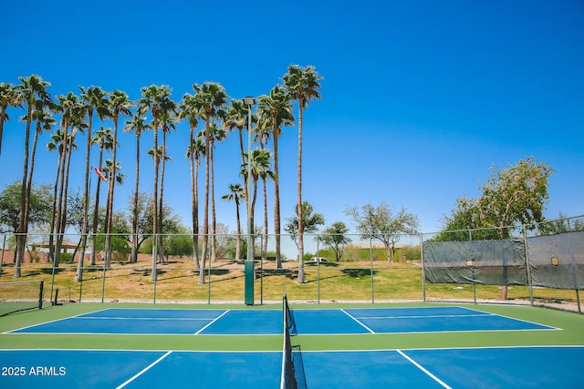 view of tennis court with community basketball court and fence