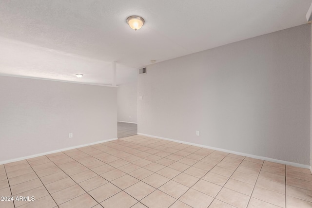 unfurnished room with light tile patterned floors