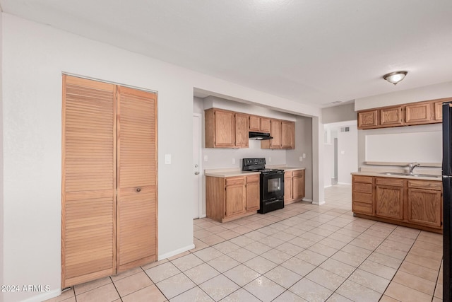 kitchen featuring light tile patterned flooring, black electric range oven, and sink