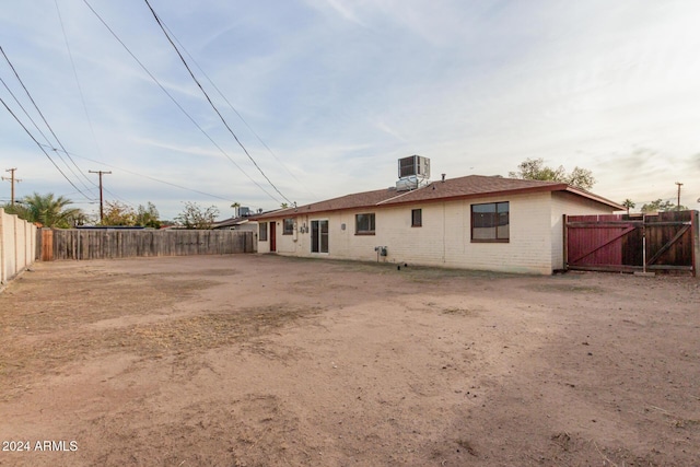 back of property featuring central AC