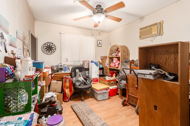 home office with light wood-type flooring, a wall mounted AC, and ceiling fan