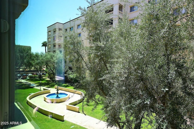 view of home's community with a lawn