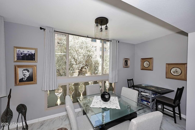 dining area featuring baseboards