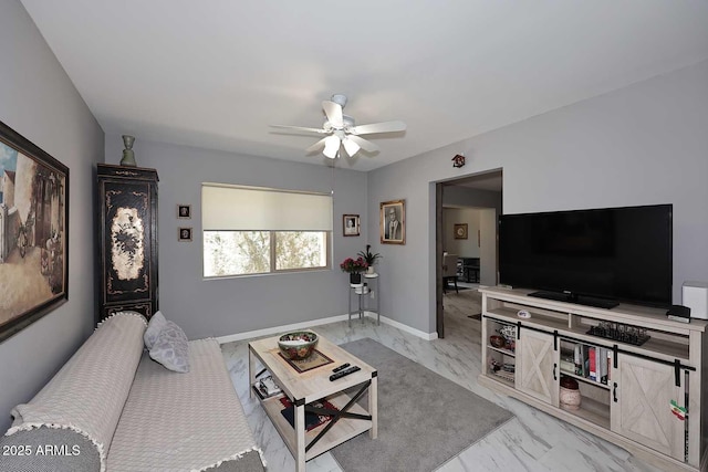 living room with marble finish floor, ceiling fan, and baseboards