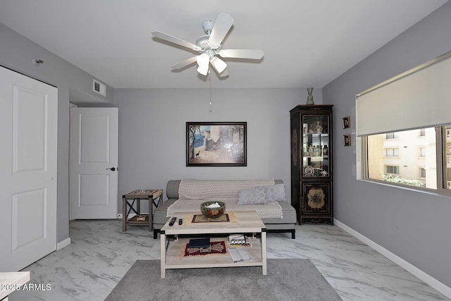 living room with ceiling fan, visible vents, marble finish floor, and baseboards