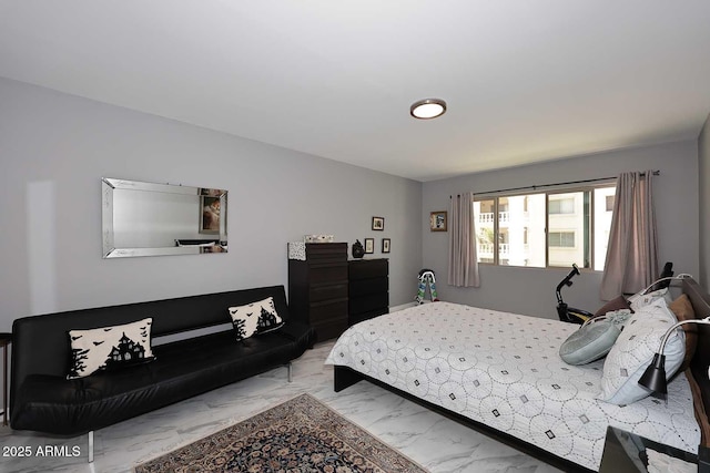 bedroom featuring marble finish floor
