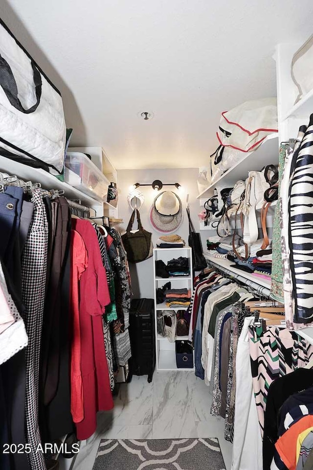 spacious closet with marble finish floor