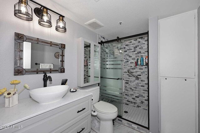 bathroom featuring visible vents, a stall shower, toilet, vanity, and marble finish floor