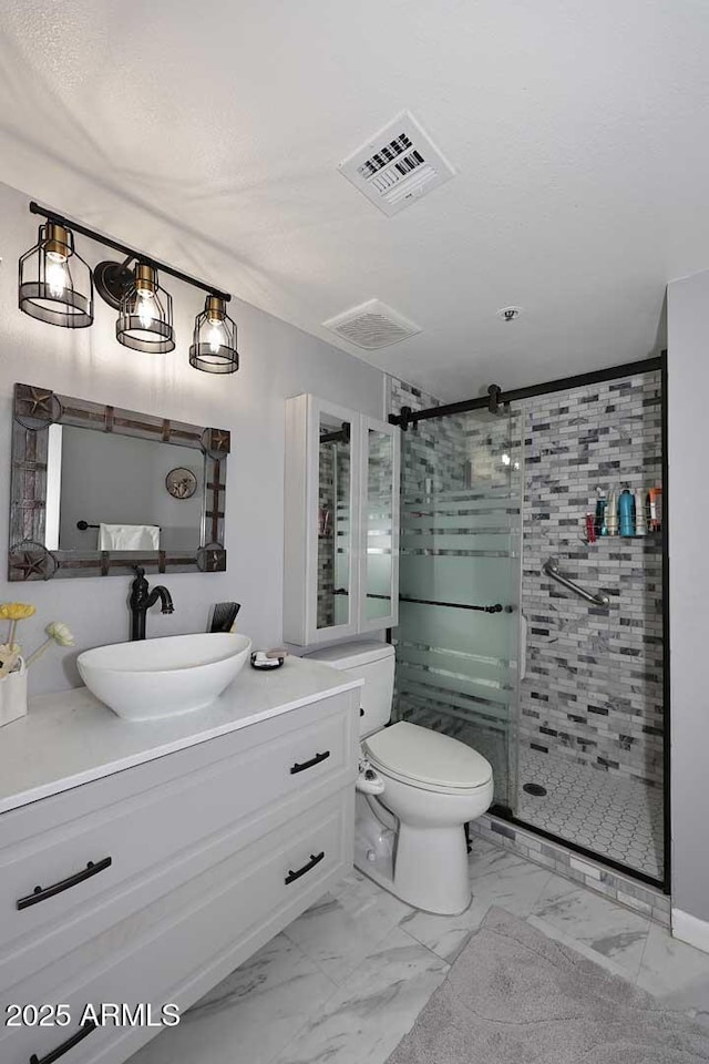 full bath featuring visible vents, a stall shower, toilet, vanity, and marble finish floor