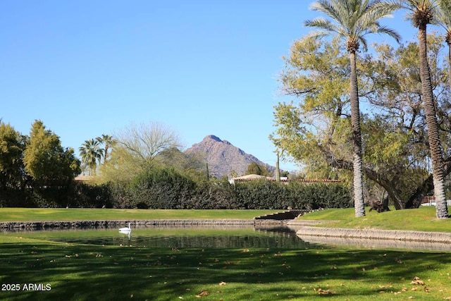 surrounding community with a lawn and a water and mountain view