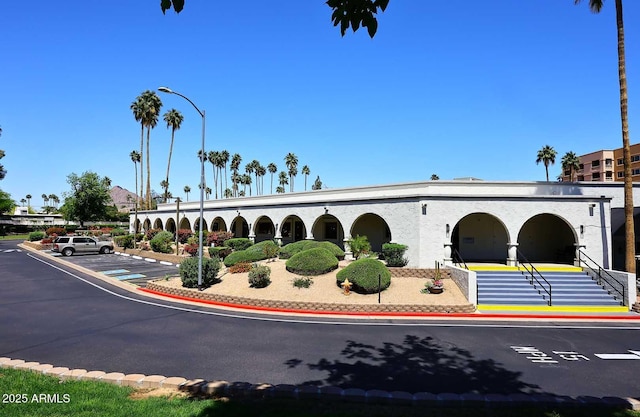 view of building exterior with uncovered parking