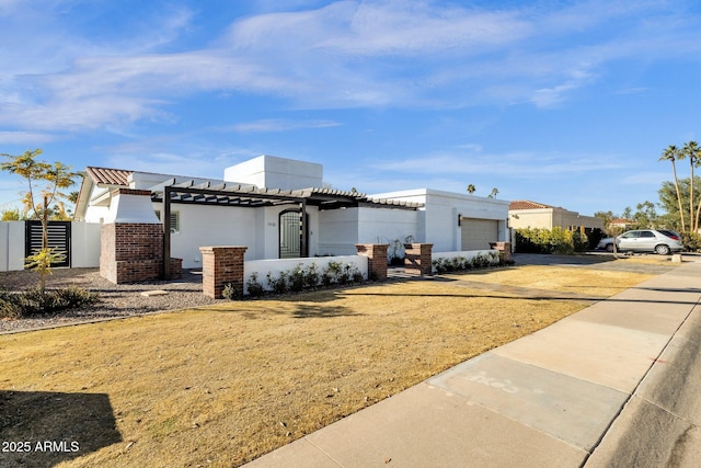 view of front of home featuring a garage and a pergola