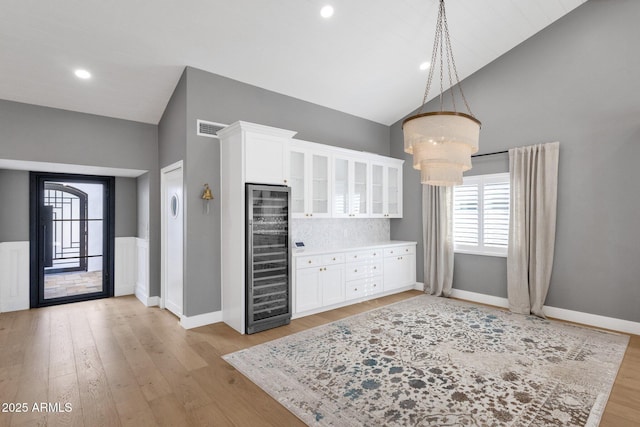 9136 N 81st St, Scottsdale, AZ 85258 - kitchen with wine cooler, pendant lighting, light hardwood / wood-style flooring, and white cabinets